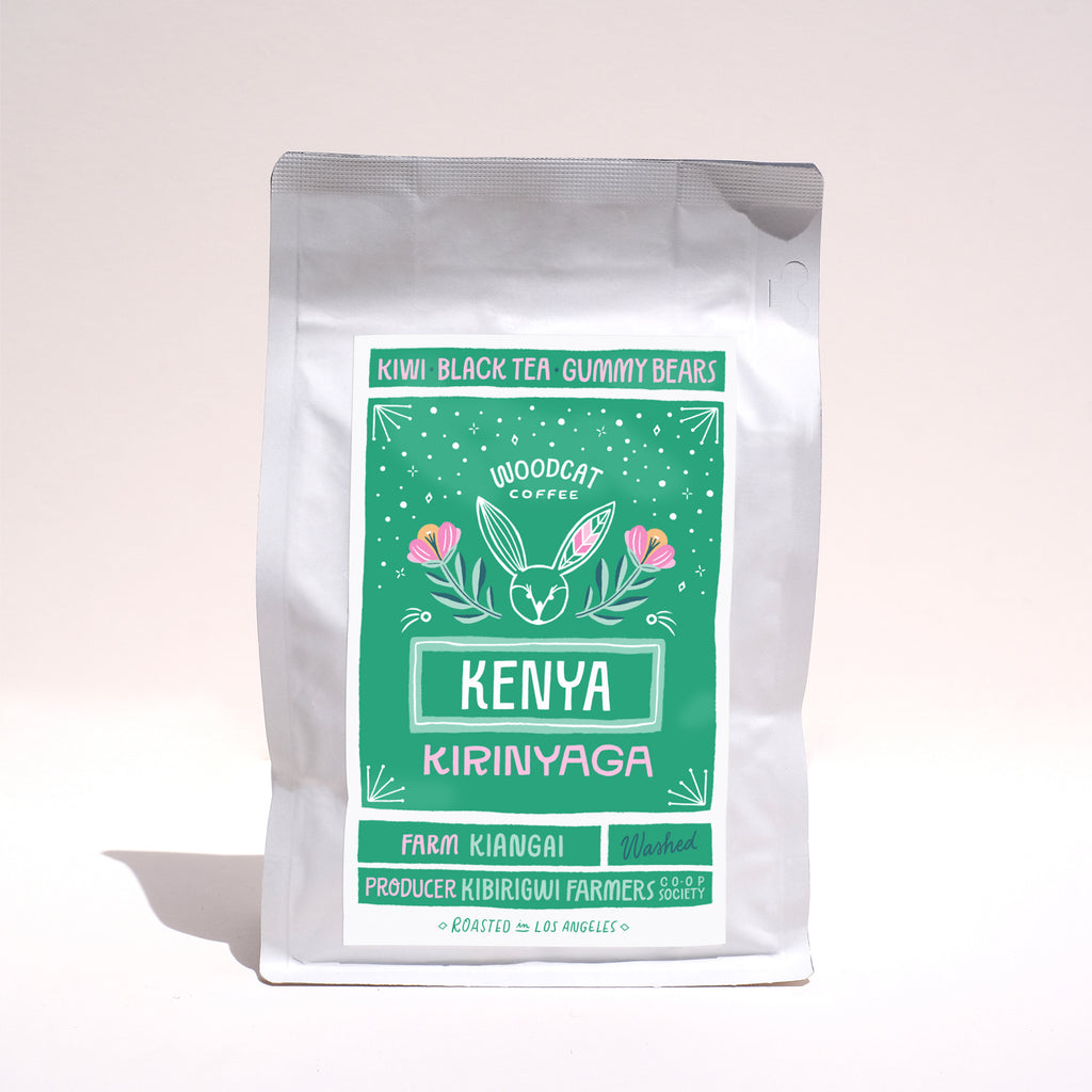 A front view of white bag with a green label that reads "Kenya Kirinyaga" in large lettering