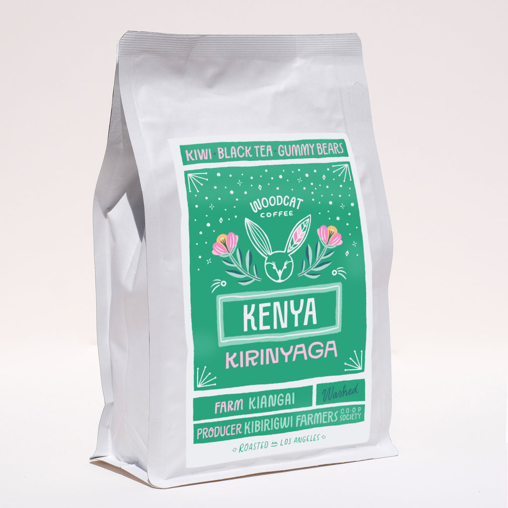 A side view of white bag with a green label that reads "Kenya Kirinyaga" in large lettering